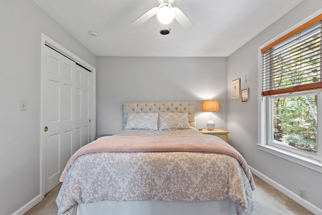9 Blanchard Road Harvard, MA 01451 - Photo 20 of 33 a bedroom with a large bed and a large window
