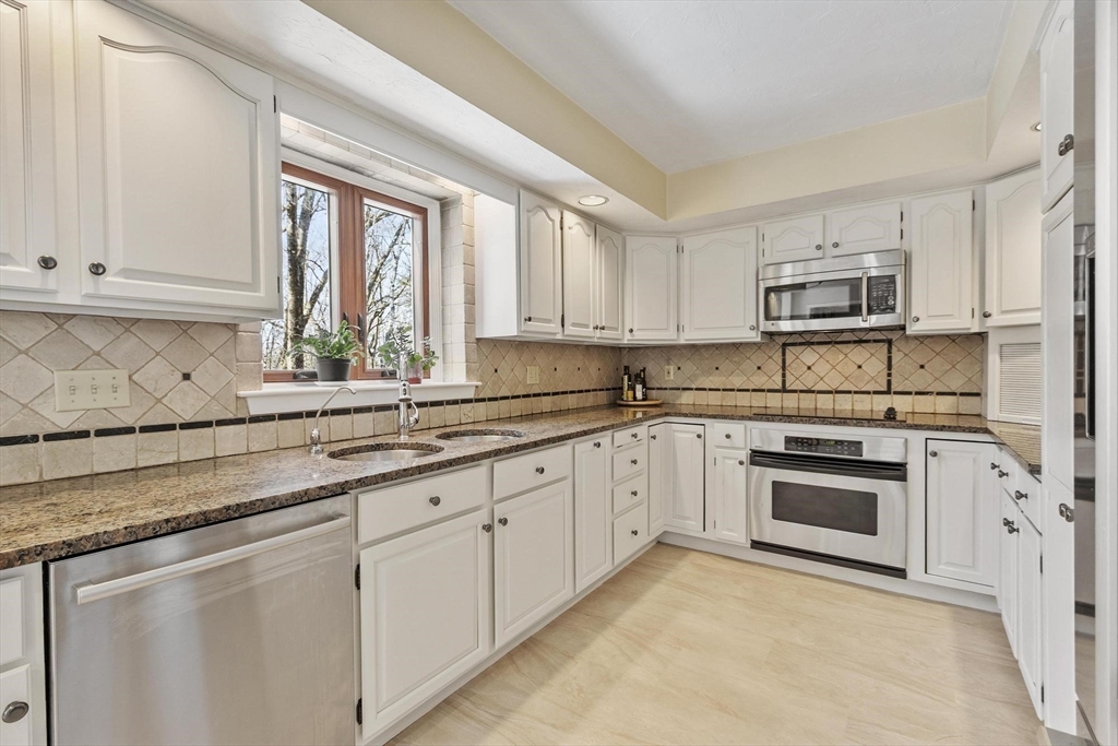 9 Blanchard Road Harvard, MA 01451 - Photo 7 of 33 a kitchen with granite countertop white cabinets and a sink