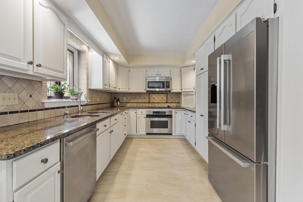9 Blanchard Road Harvard, MA 01451 - Photo 8 of 33 a large kitchen with a refrigerator sink and a stove