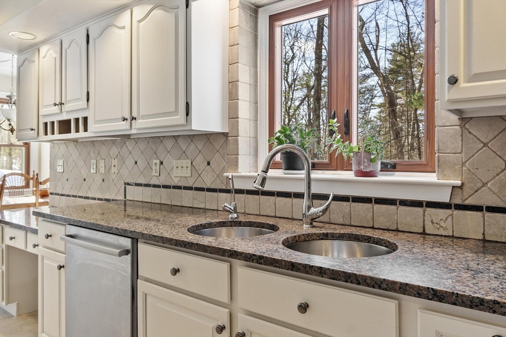 9 Blanchard Road Harvard, MA 01451 - Photo 9 of 33 a kitchen with granite countertop a sink and white cabinets