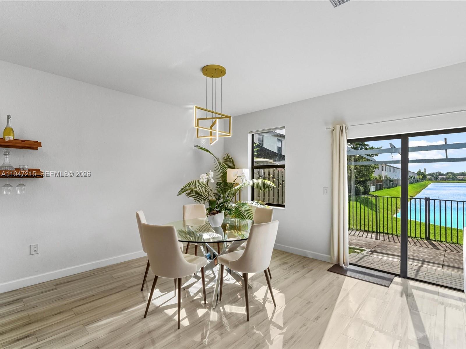 544 Northeast 206th Lane Miami, FL 33179 - Photo 12 of 48 a view of a dining room with furniture and a potted plant