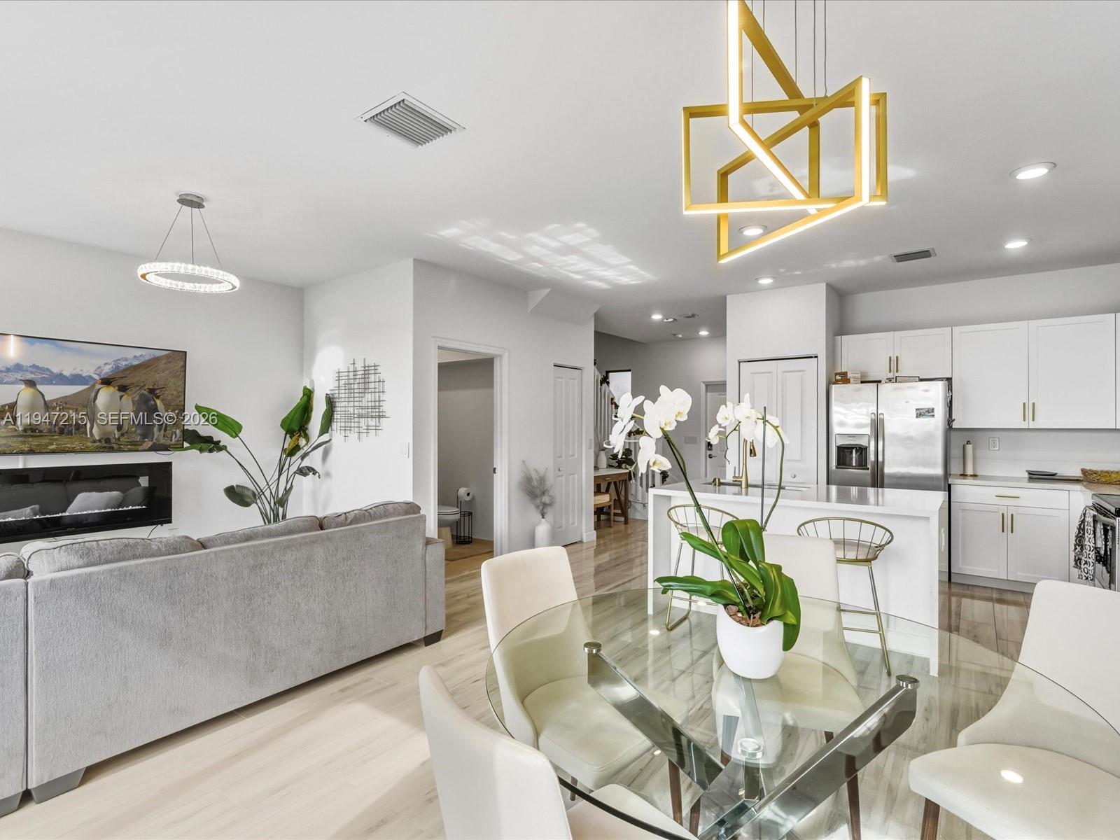 544 Northeast 206th Lane Miami, FL 33179 - Photo 14 of 48 a dining room with furniture kitchen view and a chandelier