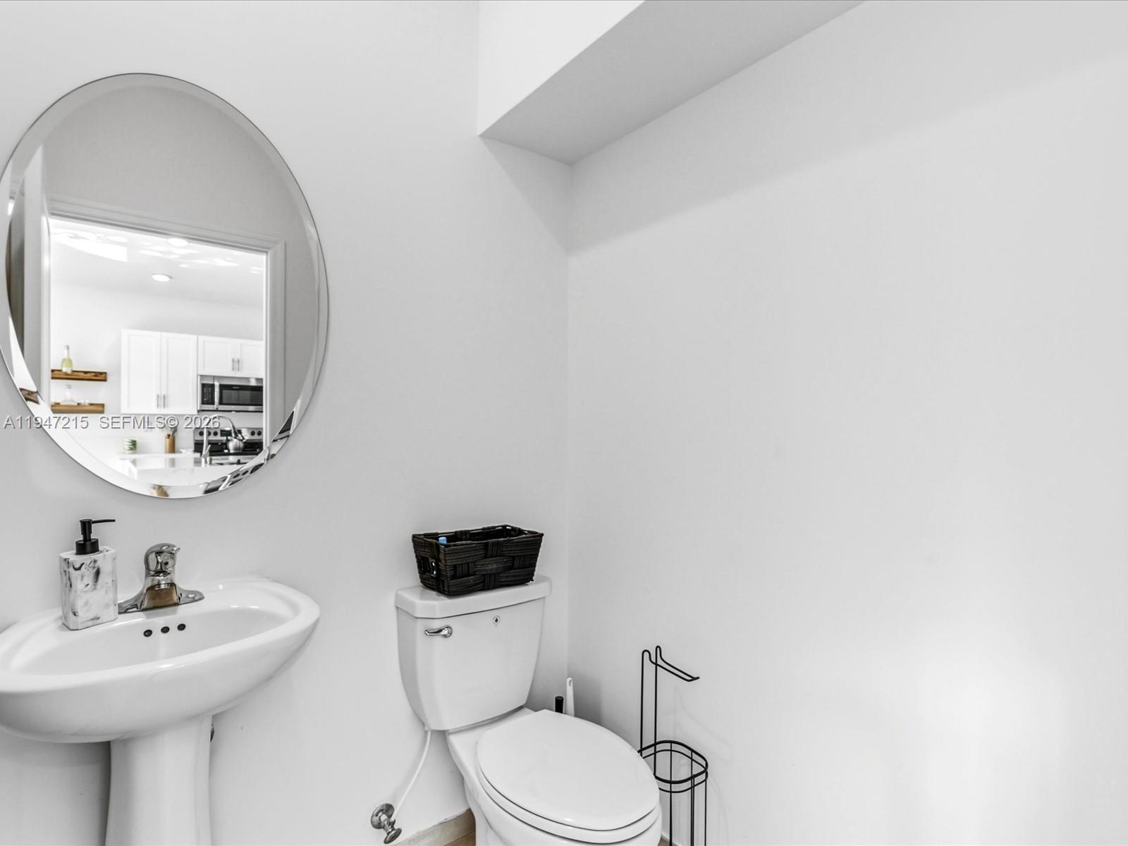 544 Northeast 206th Lane Miami, FL 33179 - Photo 18 of 48 a bathroom with a toilet a sink and mirror