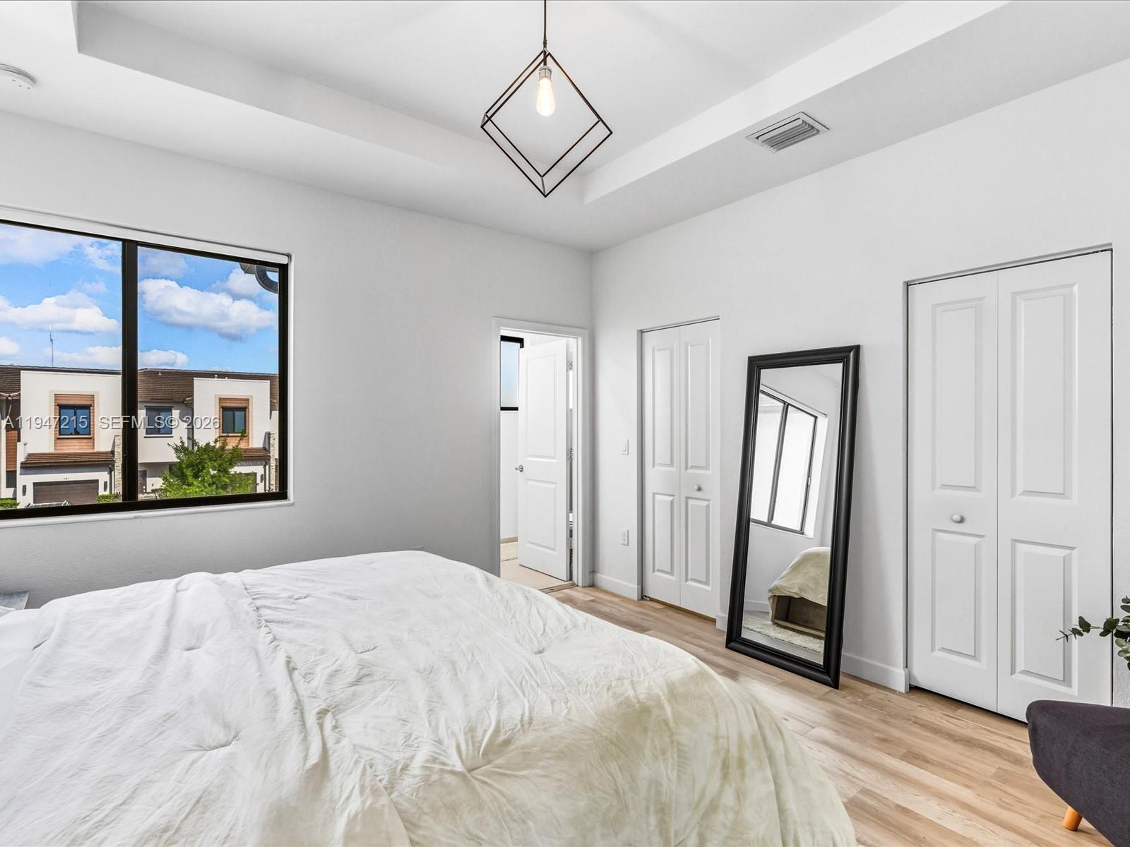 544 Northeast 206th Lane Miami, FL 33179 - Photo 19 of 48 a spacious bedroom with a large bed and a window