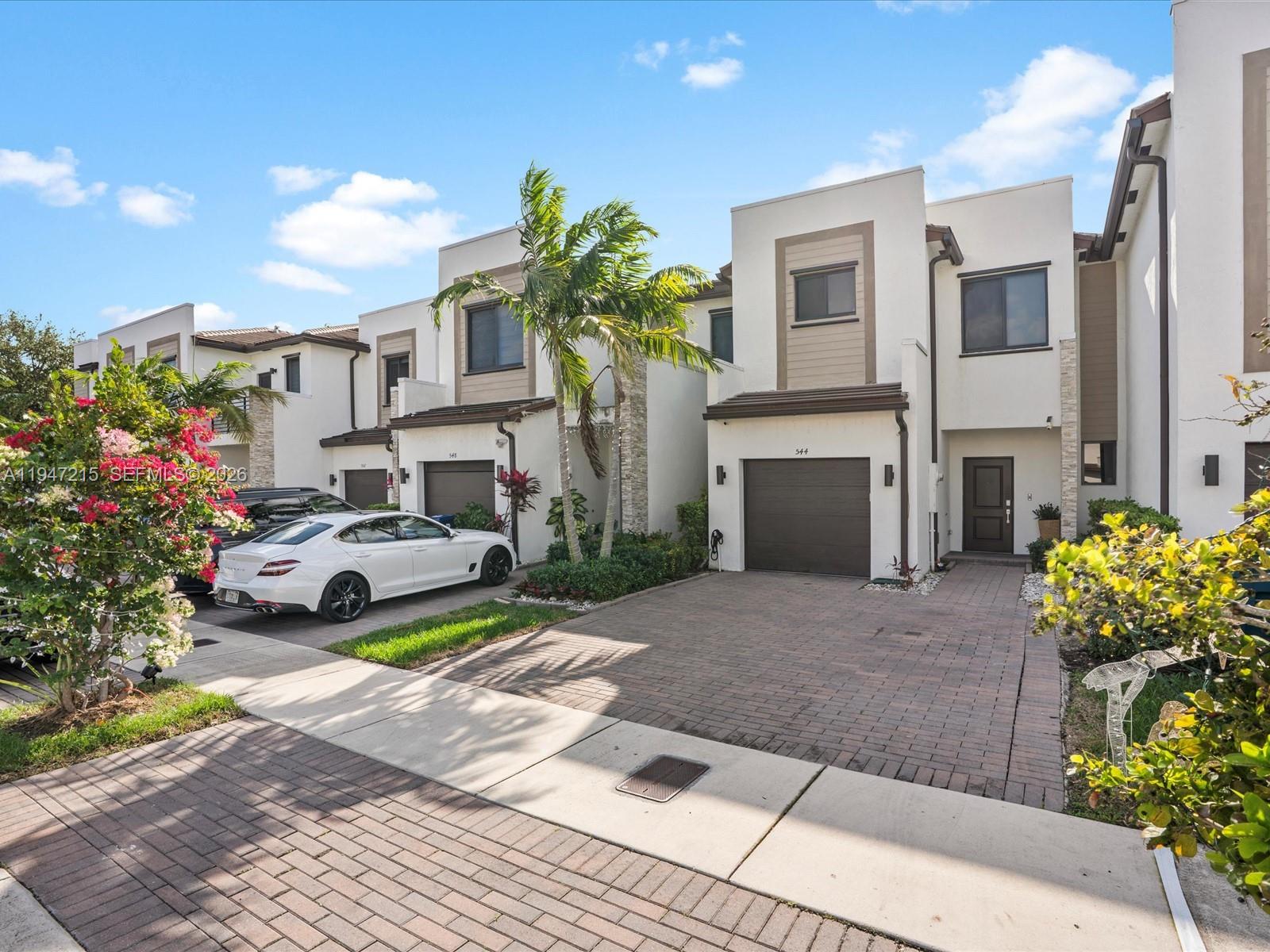544 Northeast 206th Lane Miami, FL 33179 - Photo 2 of 48 a view of a house with a yard and sitting area
