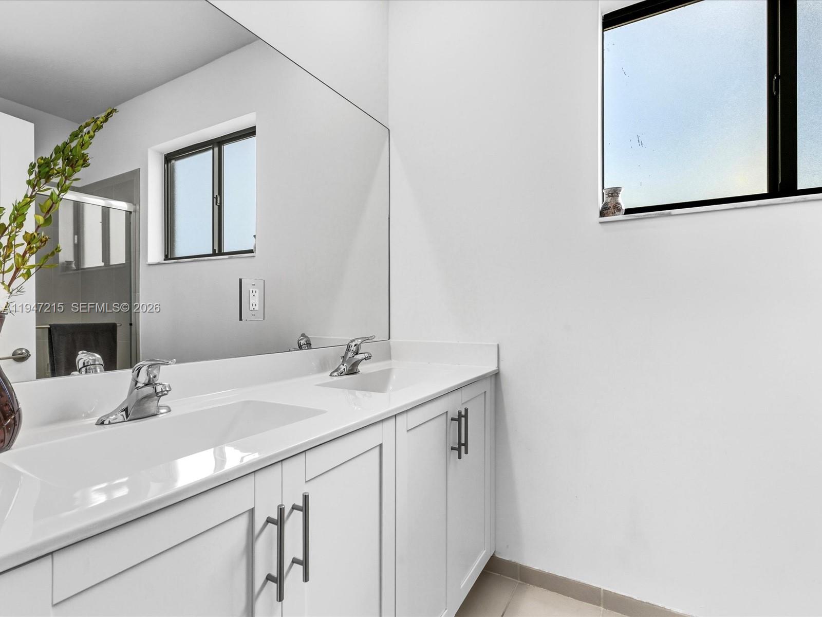 544 Northeast 206th Lane Miami, FL 33179 - Photo 22 of 48 a bathroom with a sink and a mirror