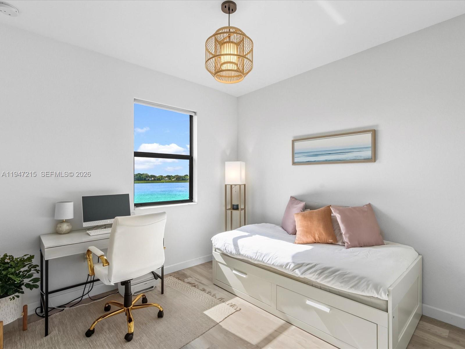 544 Northeast 206th Lane Miami, FL 33179 - Photo 23 of 48 a bedroom with a bed and a table