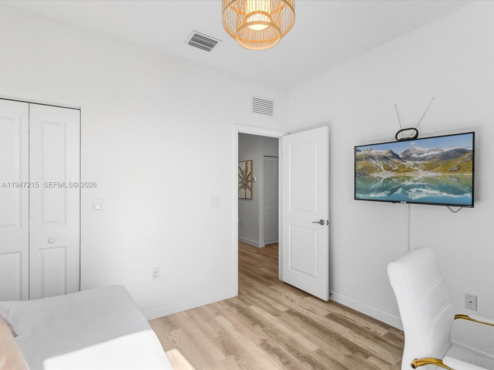 544 Northeast 206th Lane Miami, FL 33179 - Photo 24 of 48 a view of a bedroom with furniture and wooden floor