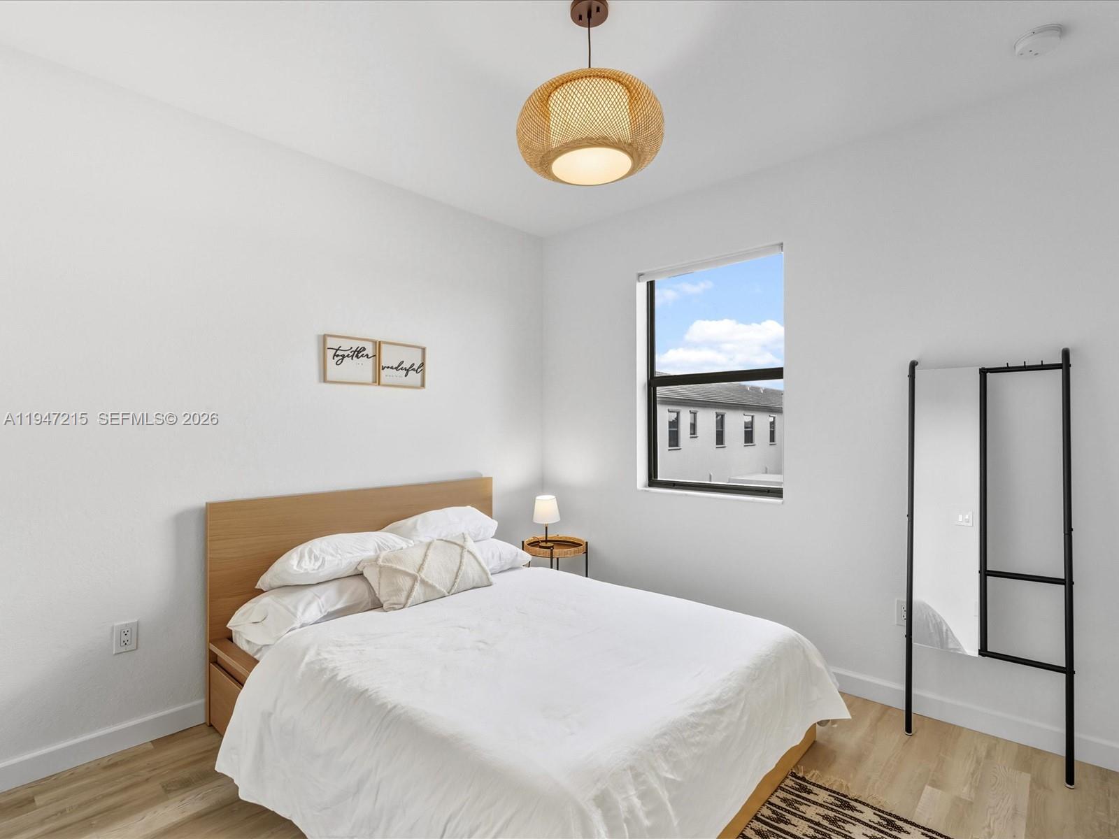 544 Northeast 206th Lane Miami, FL 33179 - Photo 25 of 48 a bedroom with a bed and painting on the wall