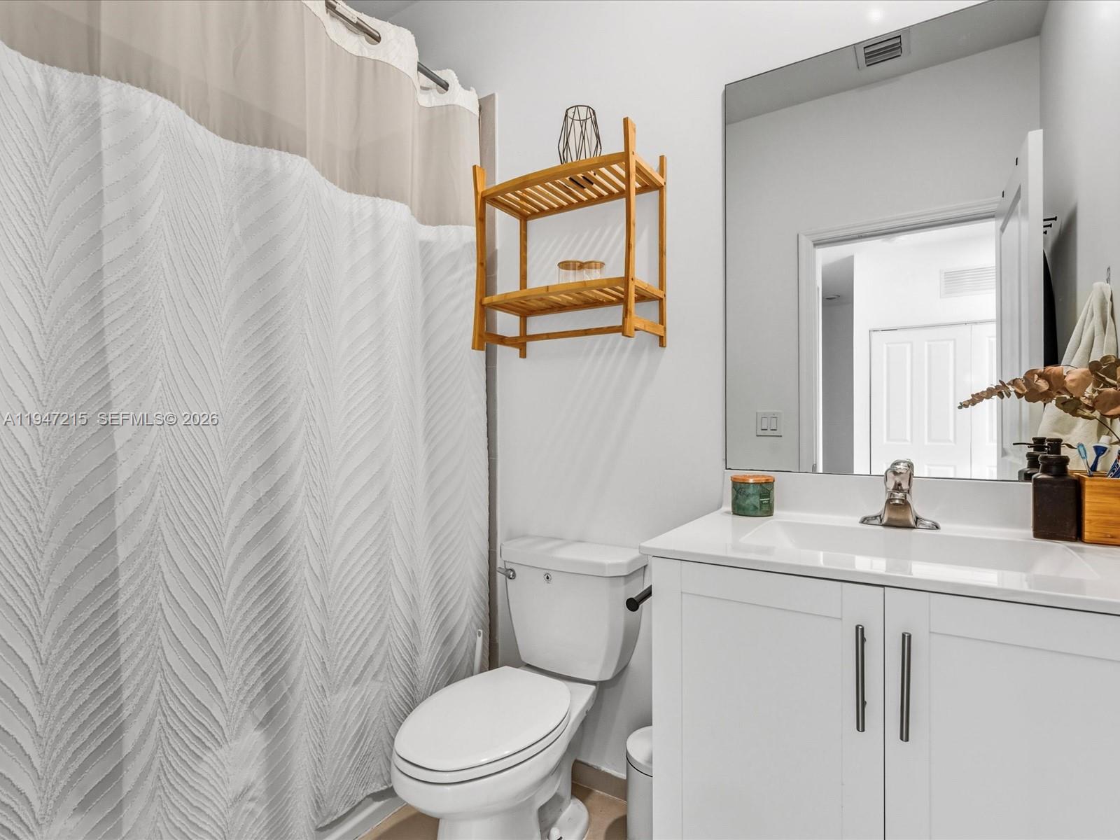 544 Northeast 206th Lane Miami, FL 33179 - Photo 30 of 48 a bathroom with a granite countertop toilet sink and mirror