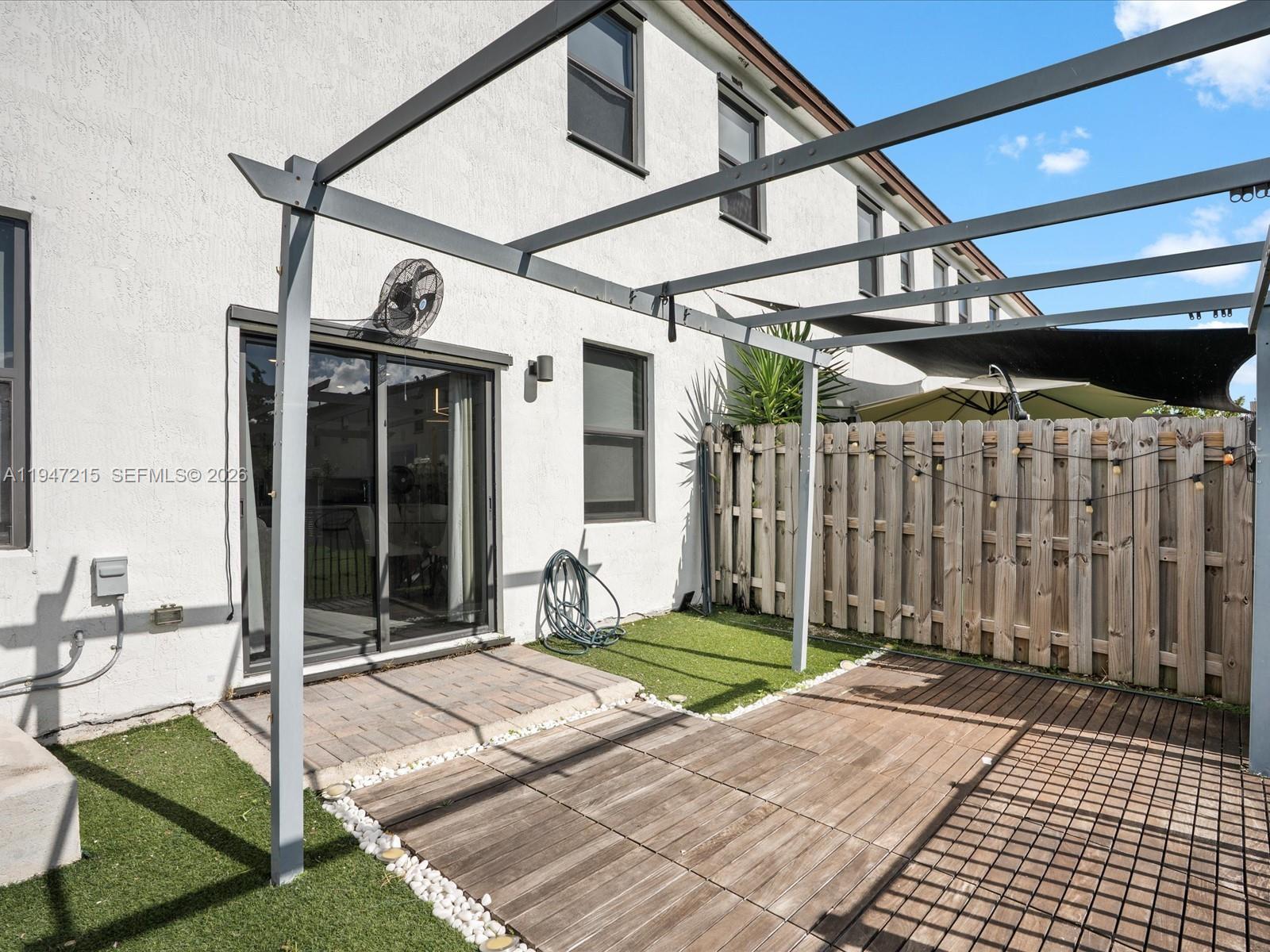 544 Northeast 206th Lane Miami, FL 33179 - Photo 34 of 48 a view of a porch with furniture and floor to ceiling window