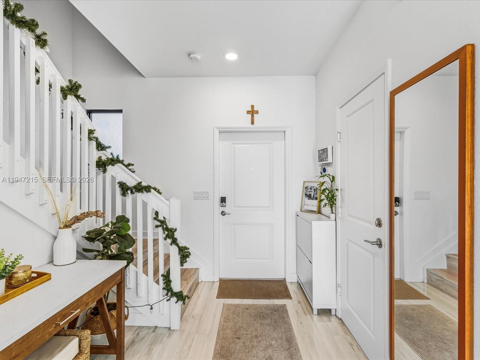 544 Northeast 206th Lane Miami, FL 33179 - Photo 4 of 48 a view of an entryway with wooden floor