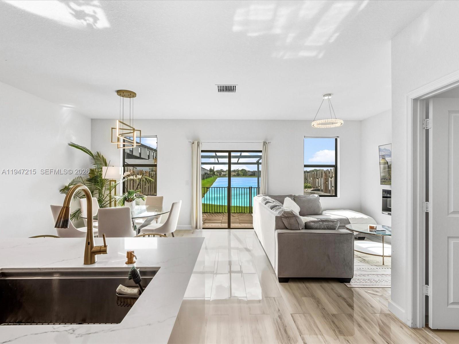 544 Northeast 206th Lane Miami, FL 33179 - Photo 7 of 48 a living room with furniture and a large window