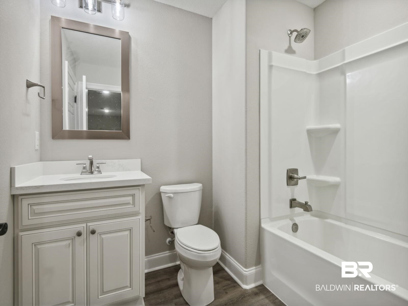 12943 Gondala Street Elberta, AL 36530 - Photo 15 of 23 Bathroom featuring shower / bathtub combination, dark wood-style floors, and vanity