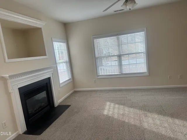 a living room with a fireplace and a window