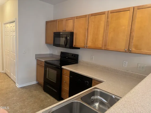 a kitchen with a sink cabinets and a microwave