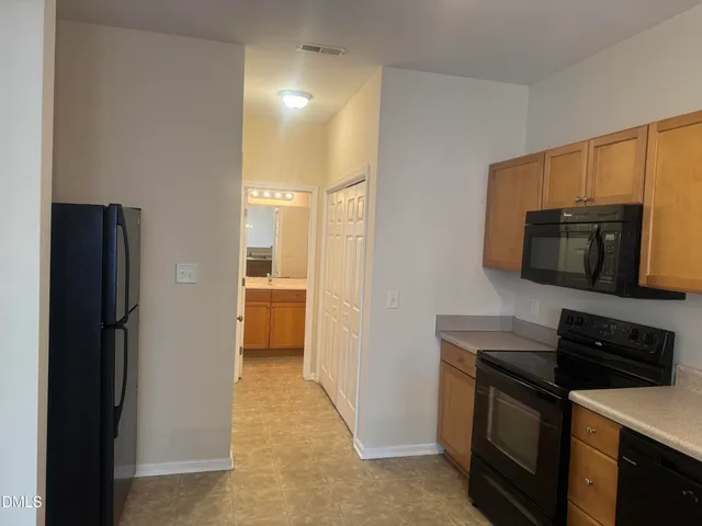 a kitchen with a refrigerator stove and microwave