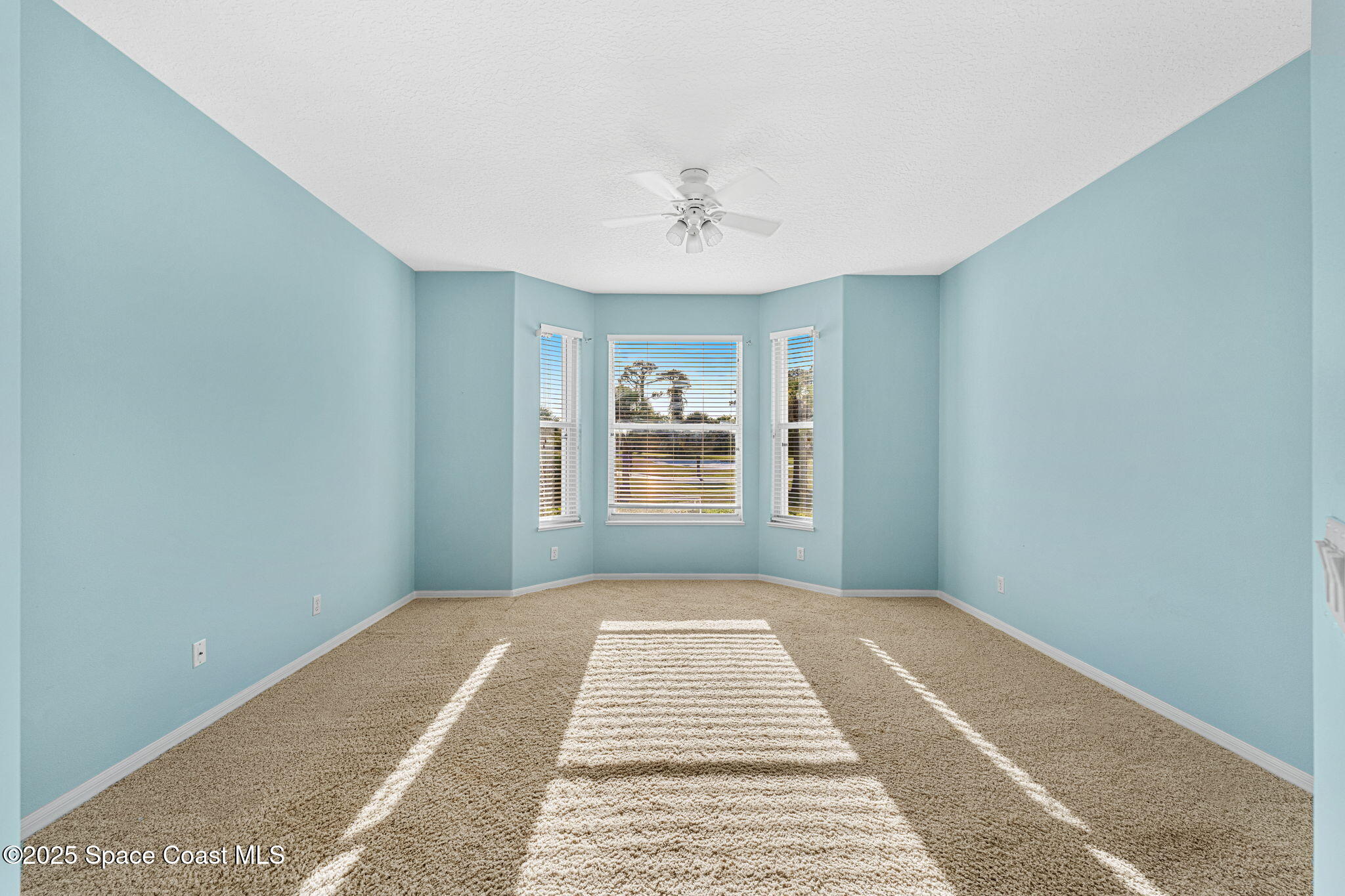 4221 Aberdeen Circle Rockledge, FL 32955 - Photo 12 of 45 a view of a big room with windows and chandelier fan