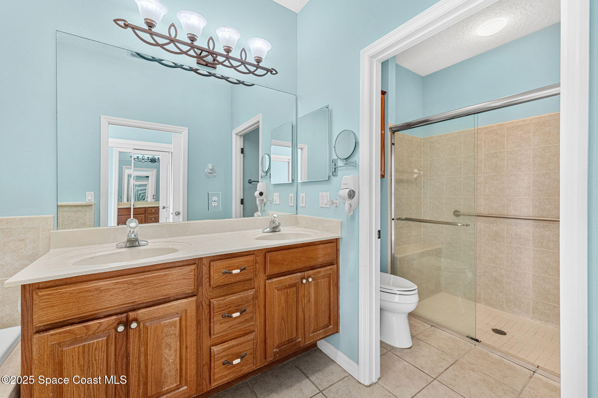 4221 Aberdeen Circle Rockledge, FL 32955 - Photo 15 of 45 a spacious bathroom with a double vanity sink mirror and toilet