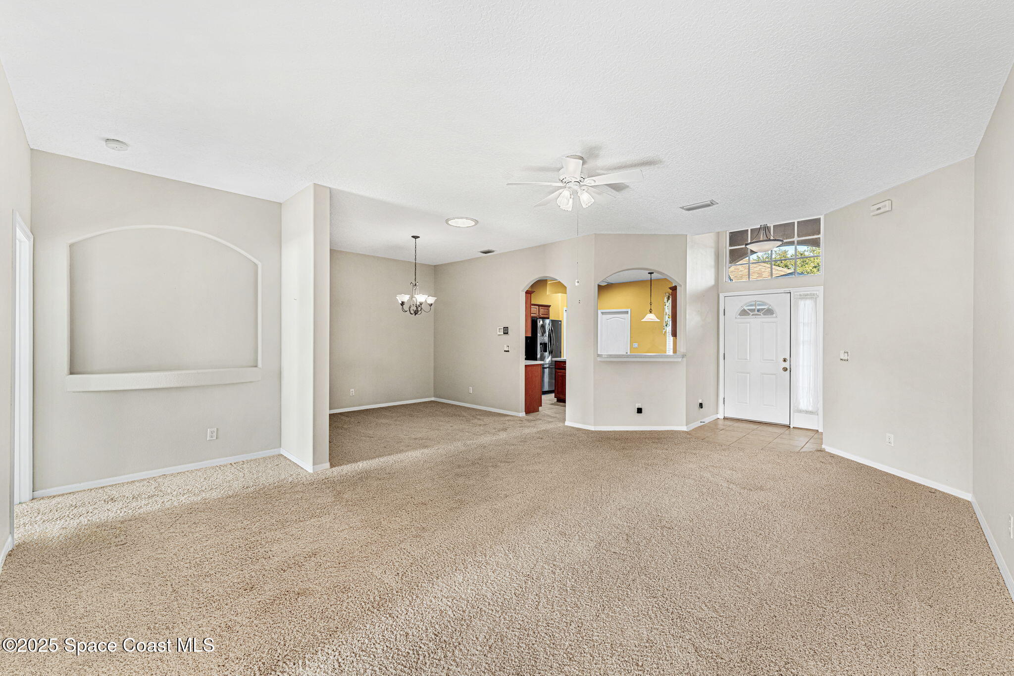 4221 Aberdeen Circle Rockledge, FL 32955 - Photo 16 of 45 an empty room with chandelier fan and windows