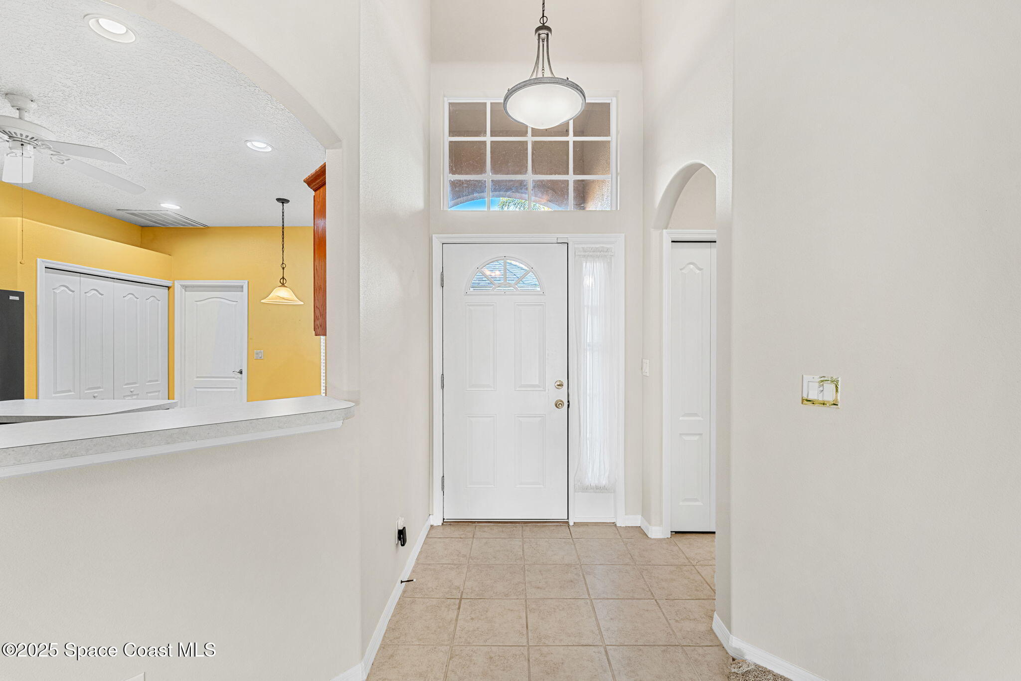 4221 Aberdeen Circle Rockledge, FL 32955 - Photo 19 of 45 a view of a hallway to a window and chandelier