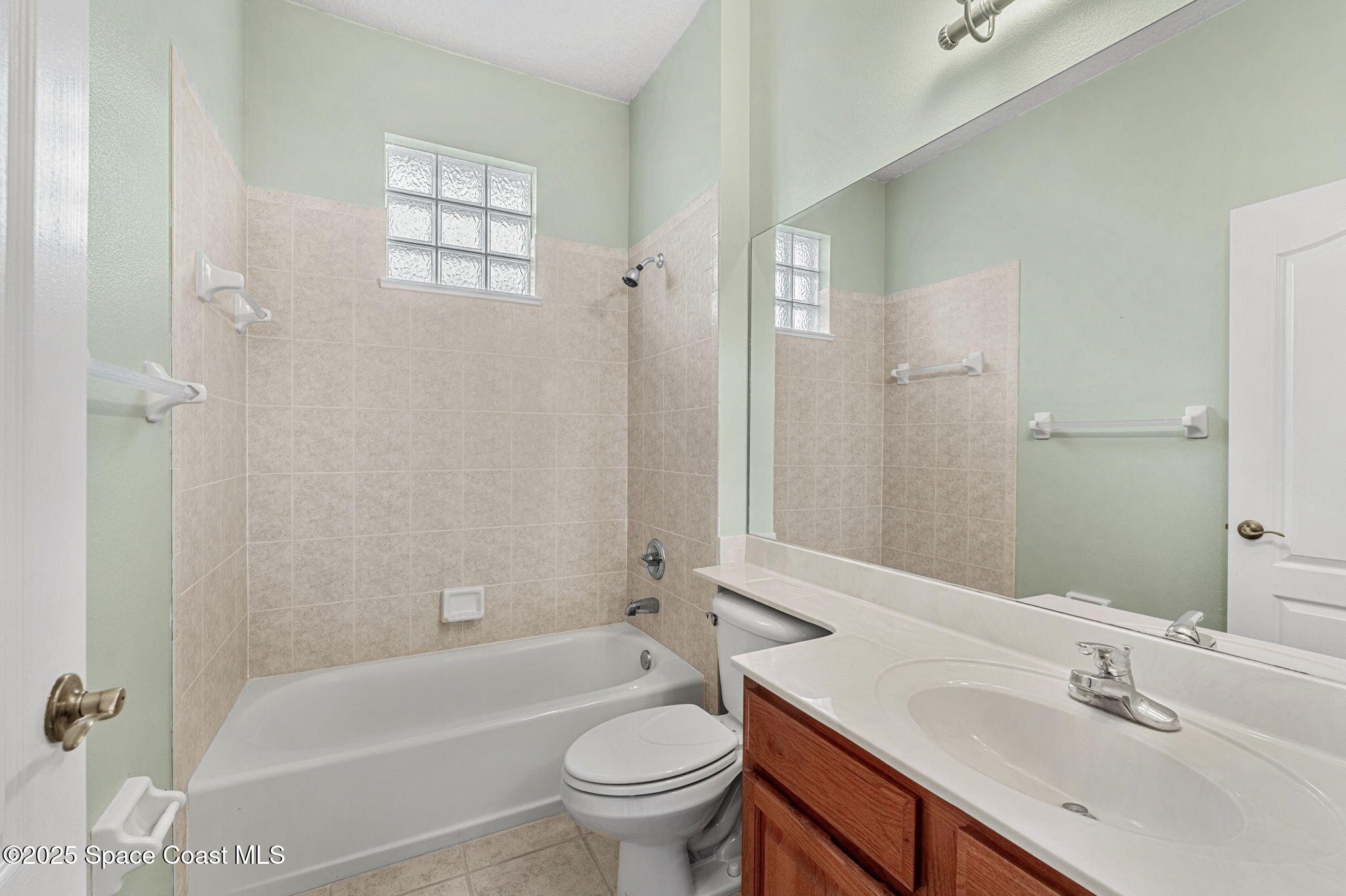 4221 Aberdeen Circle Rockledge, FL 32955 - Photo 24 of 45 a bathroom with a sink a toilet a mirror a bathtub and shower