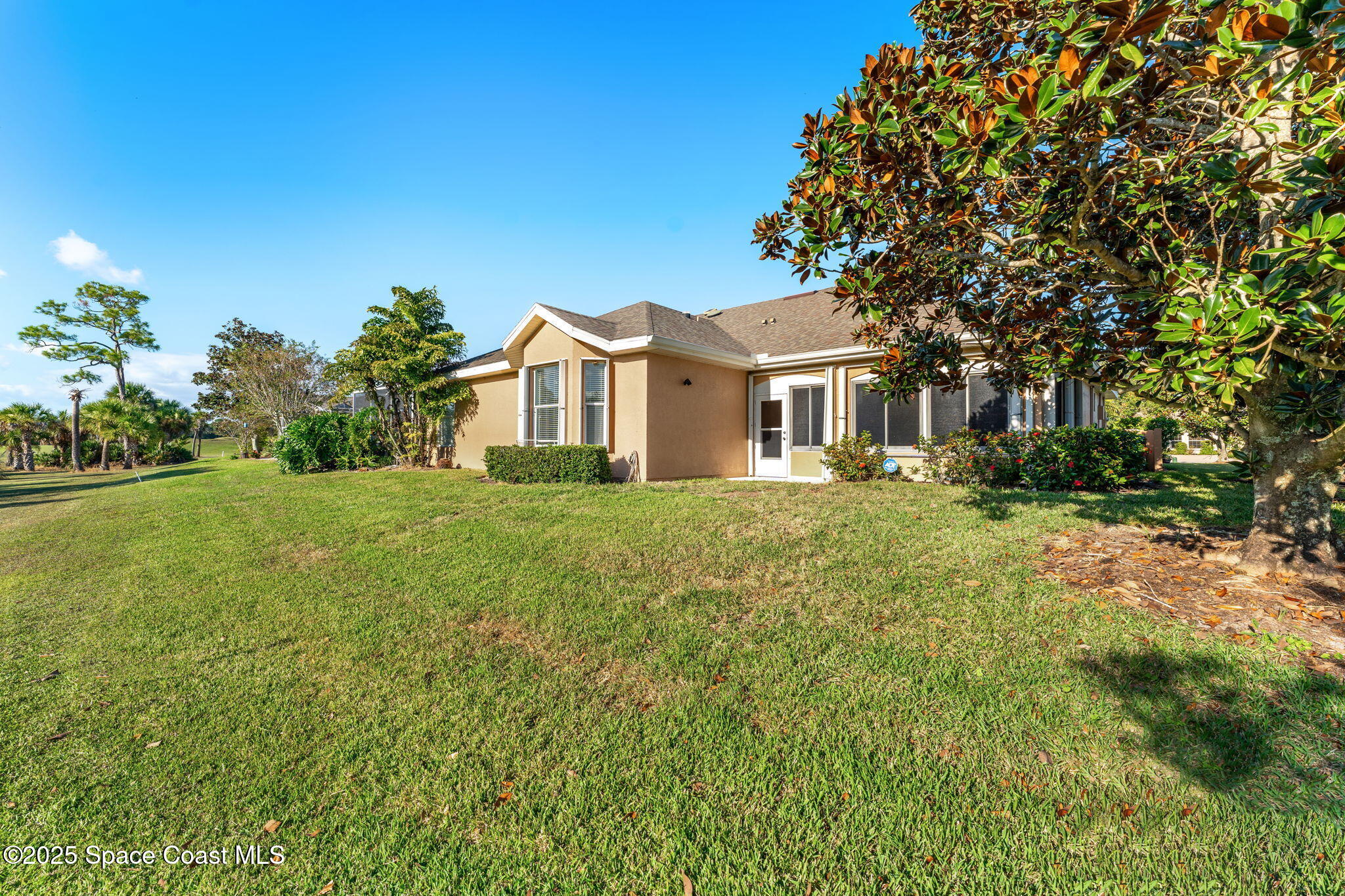4221 Aberdeen Circle Rockledge, FL 32955 - Photo 30 of 45 a front view of a house with a garden