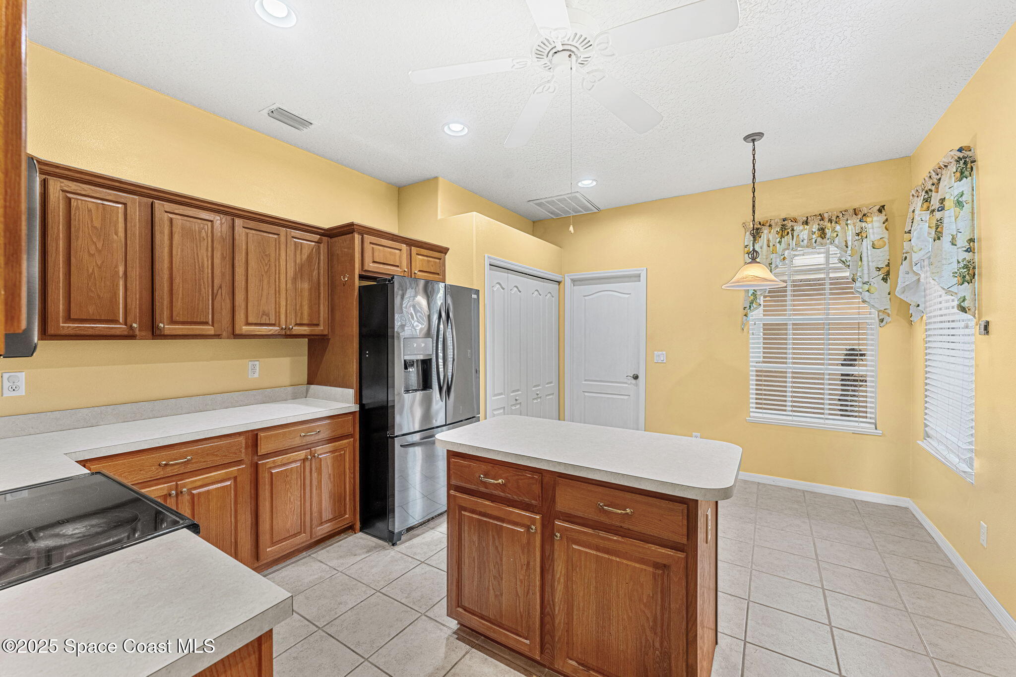 4221 Aberdeen Circle Rockledge, FL 32955 - Photo 7 of 45 a kitchen with stainless steel appliances granite countertop a refrigerator and a sink