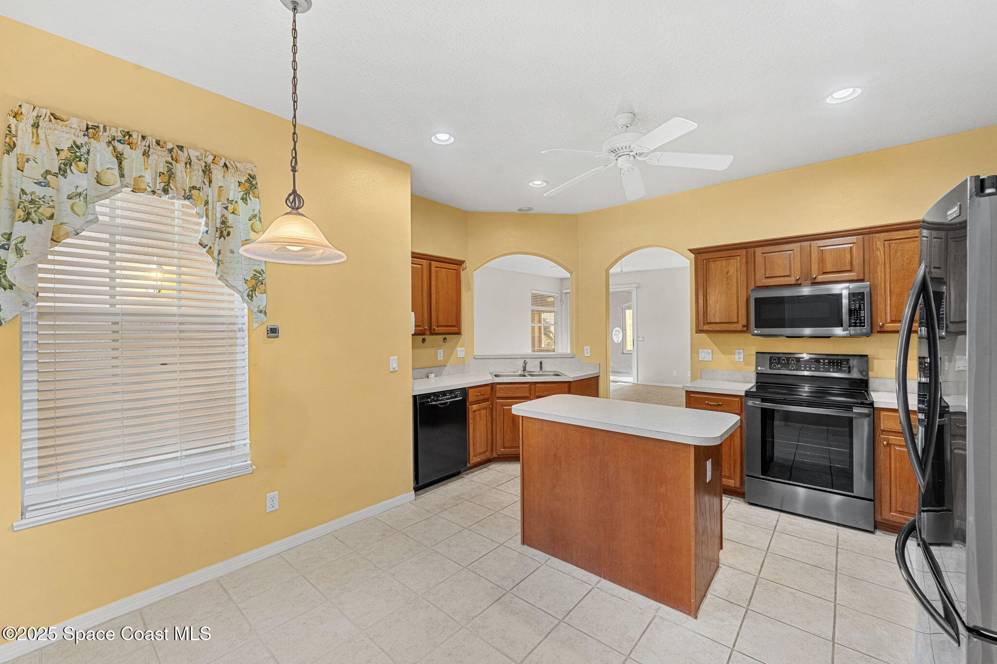 4221 Aberdeen Circle Rockledge, FL 32955 - Photo 9 of 45 a kitchen with stainless steel appliances granite countertop a sink a stove and a refrigerator