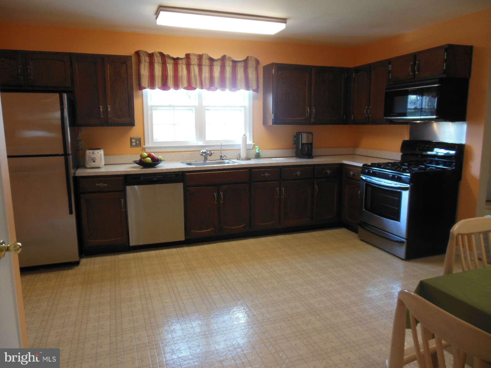 1608 Arbor View Road Silver Spring, MD 20902 - Photo 5 of 28 a kitchen with stainless steel appliances granite countertop a stove a sink dishwasher and a refrigerator