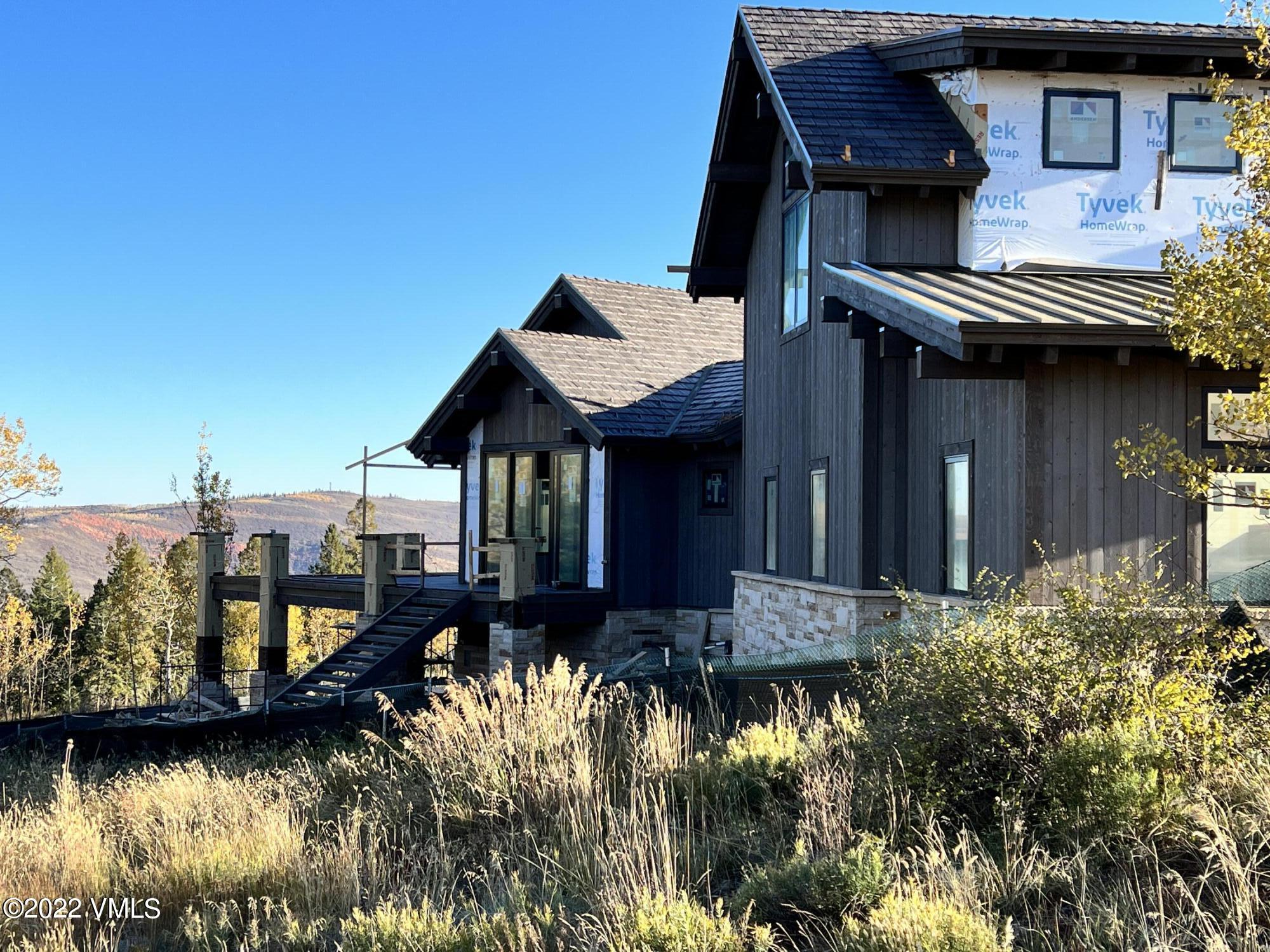 29 Kimberwick Way Edwards, CO 81632 - Photo 11 of 46 a view of a house with a yard next to a lake