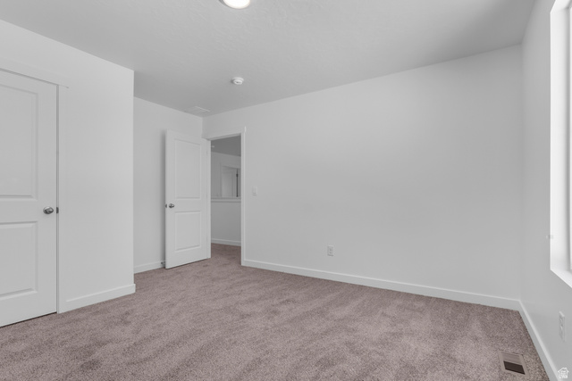1355 West 2350 South, Unit 11 Perry, UT 84302 - Photo 21 of 39 Carpeted room featuring white walls, a single window, and multiple white doors with brushed nickel hardware