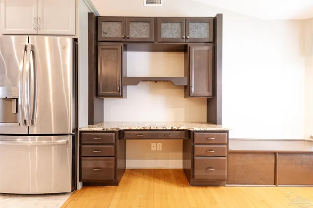 a kitchen with stainless steel appliances granite countertop a refrigerator and a stove