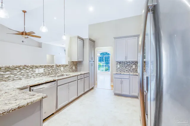 a bathroom with a granite countertop sink a toilet a shower and mirror