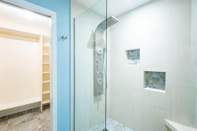 a bathroom with a glass shower door
