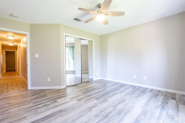 an empty room with wooden floor and door