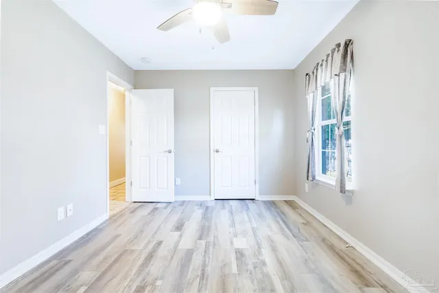 a view of room with window and hardwood floor