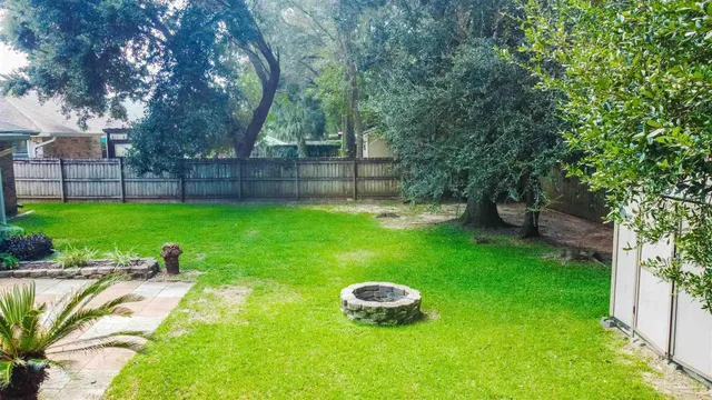 a view of a backyard with large trees
