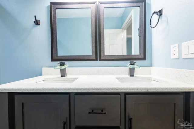 a bathroom with a sink vanity and a mirror