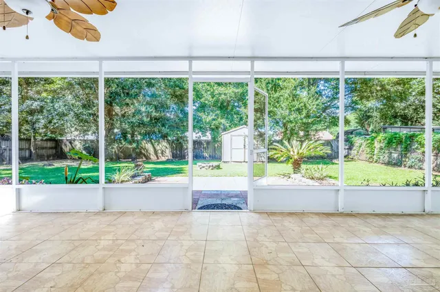 a view of a patio with a yard and table and chairs
