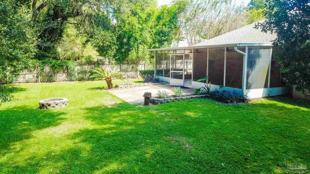 a view of a house with backyard and sitting area