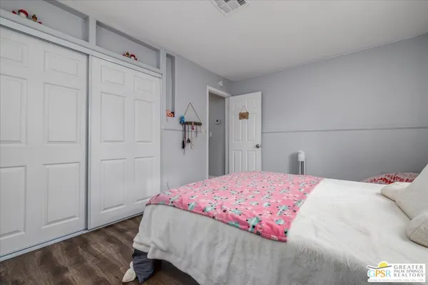 a bedroom with a bed and a closet
