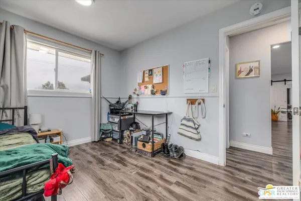 a bedroom with furniture and a window