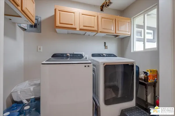 a utility room with sink dryer and washer