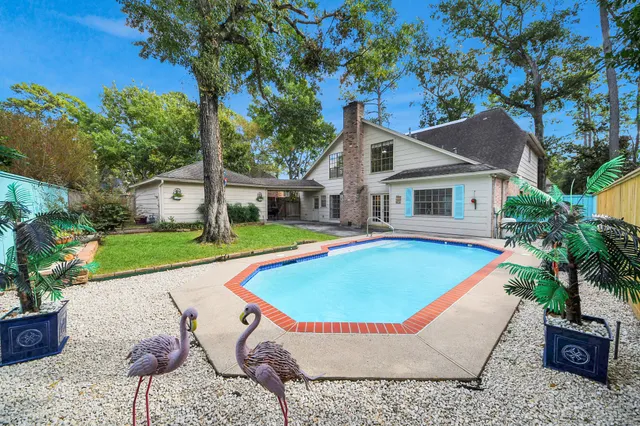 a house with swimming pool in front of it