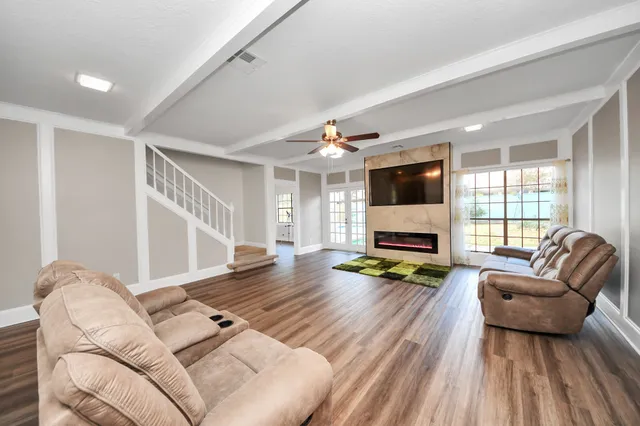 a living room with furniture and a flat screen tv