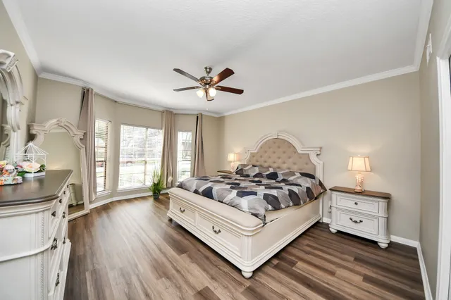 a spacious bedroom with a bed and a chandelier