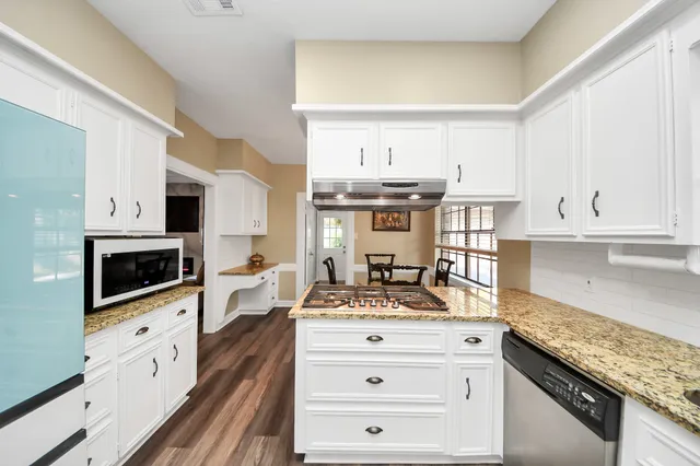 a kitchen with stainless steel appliances a stove microwave and cabinets