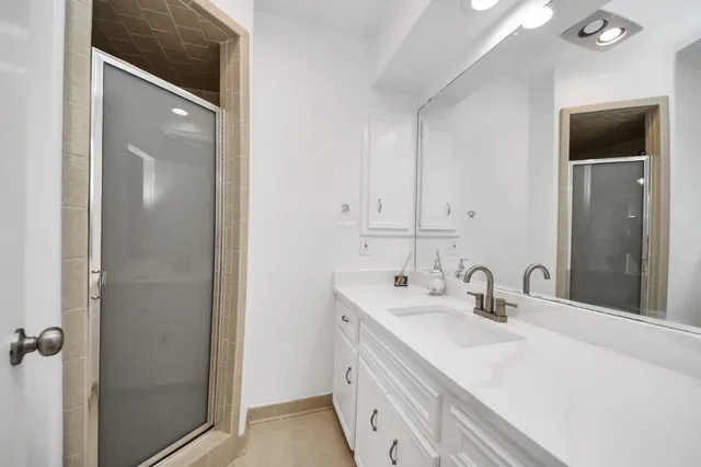 a bathroom with a double vanity sink and mirror
