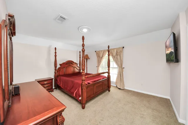 a bedroom with bed and window